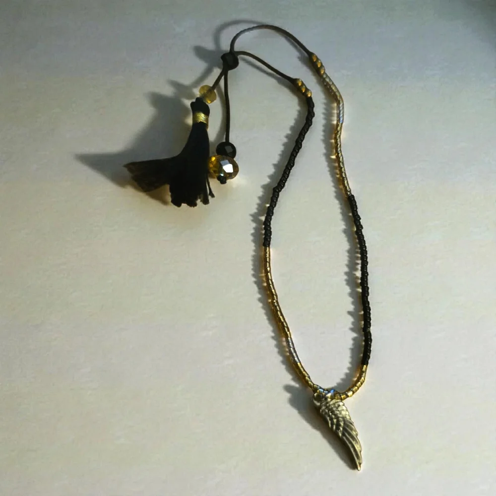 Gold Wing Charm Bracelets. One‎ With Black Accents And One With Blue.